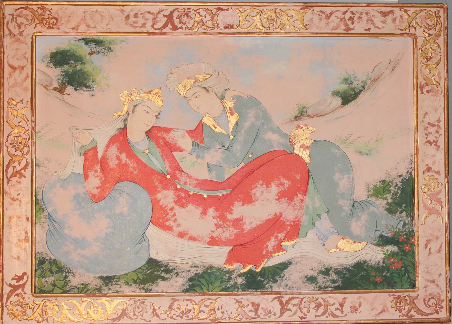 Persian miniature of two figures resting in a garden landscape