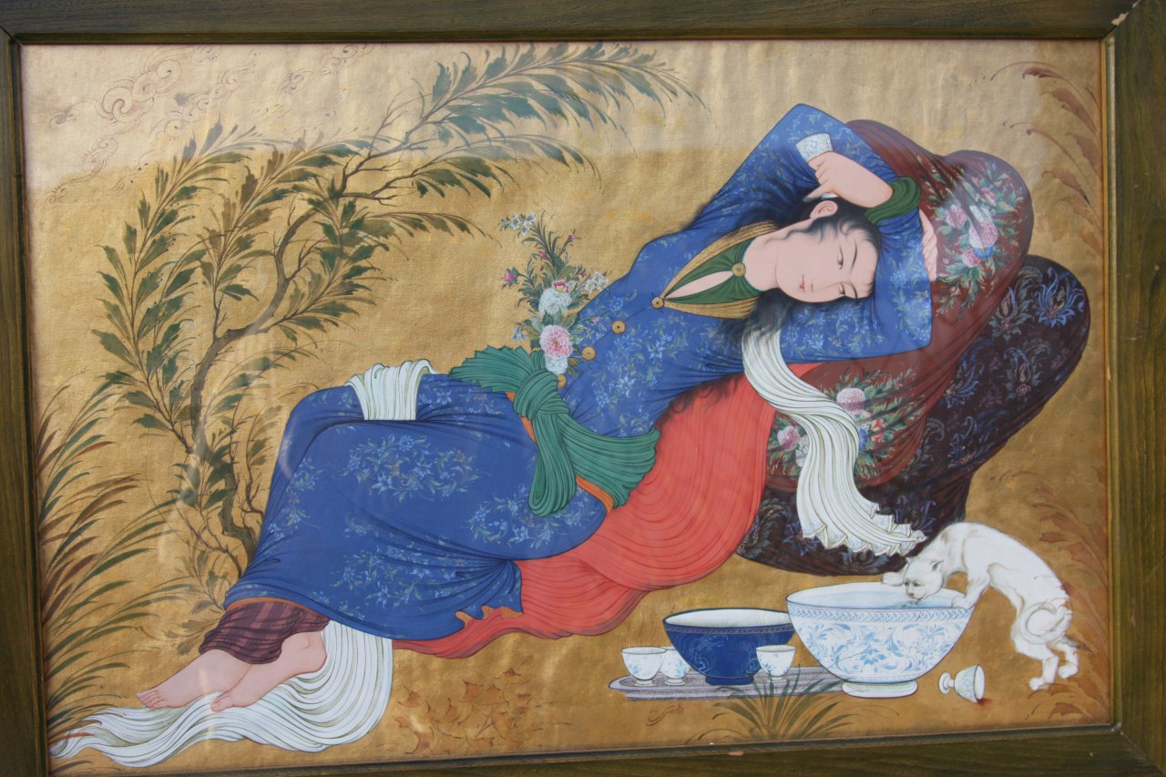 Persian miniature of a reclining woman in blue with a cat drinking from a bowl