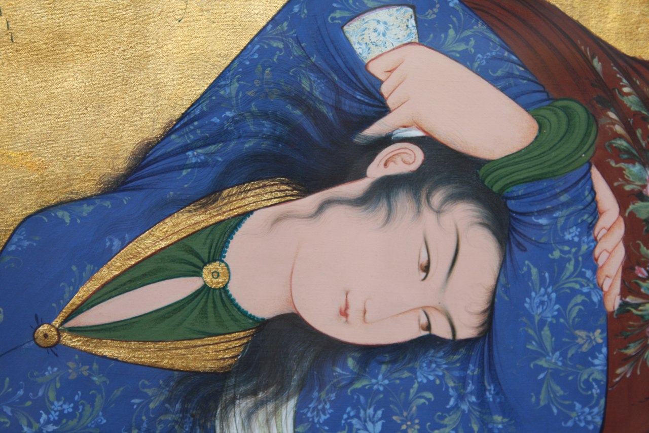 Detail of a Persian miniature figure in blue robes on gold leaf ground